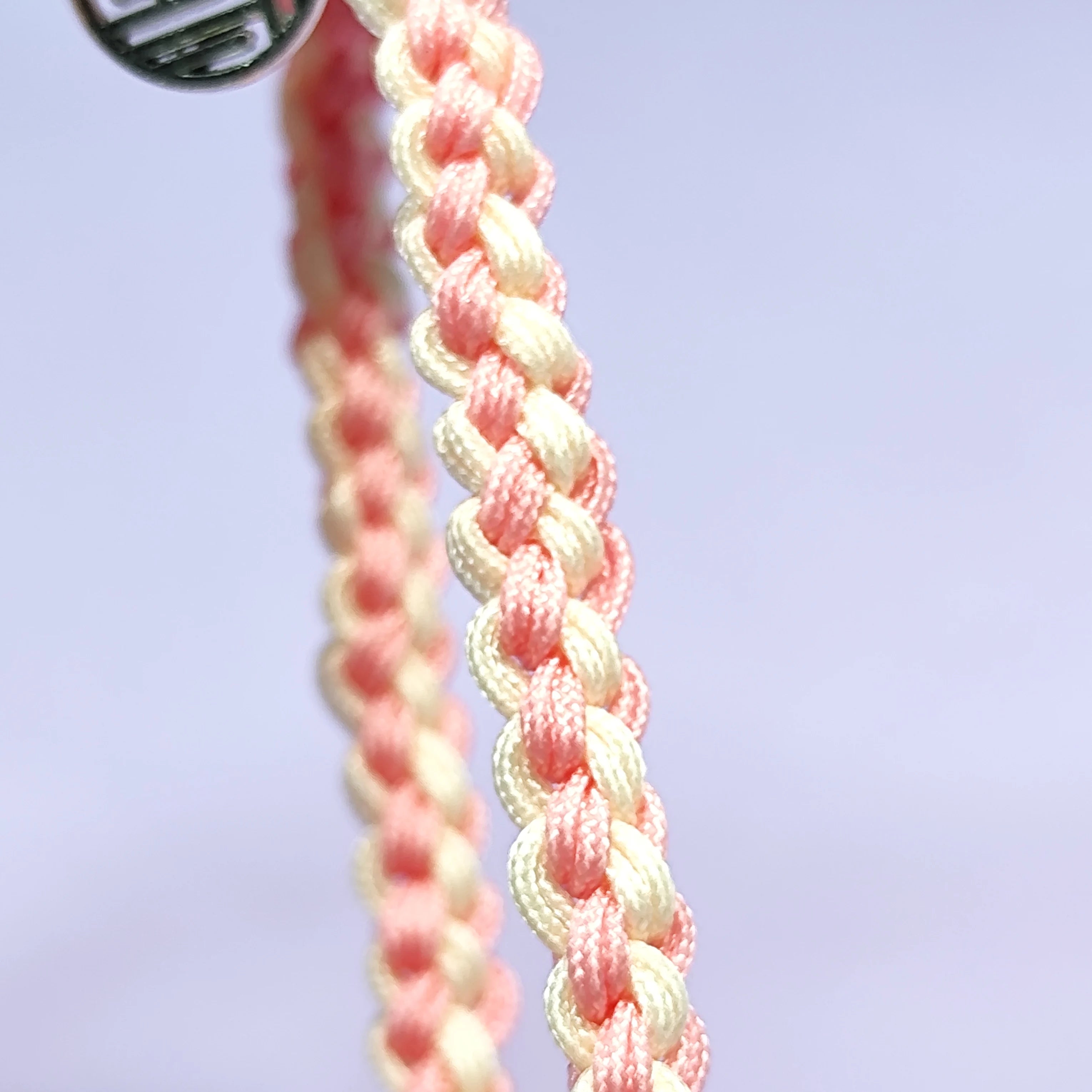 Hand - braided bracelet with a pink bear charm, beads, and a silver pendant. Cute and delicate accessory.